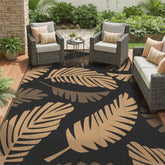 GENIMO alfombra exterior frontal mostrando el patrón reversible y estilo palm leaf
