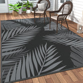 GENIMO alfombra exterior frontal mostrando patrón de hojas y color negro gris
