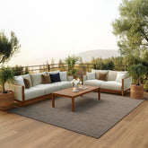 Nourison alfombra Positano frente y empaque mostrando diseño natural y beneficio duradero