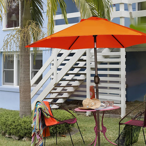 Blissun sombrilla desplegada sobre mesa exterior creando zona de sombra agradable