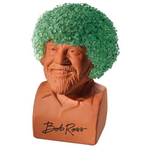 Chia Bob Ross en uso sobre mesa con brotes verdes para decoración rápida