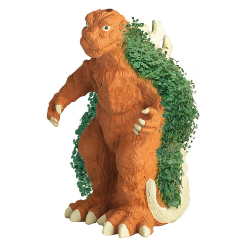 Chia Godzilla comparado con manos para mostrar tamaño y facilidad manejo