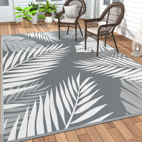 GENIMO alfombra exterior frontal mostrando patrón hojas de palma y estilo decorativo