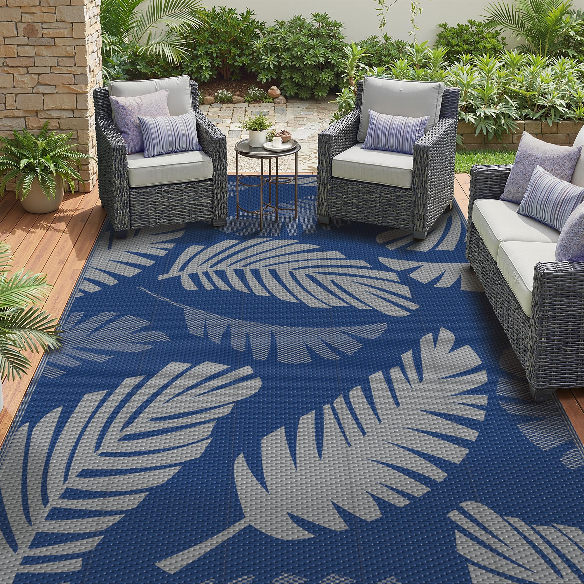 GENIMO alfombra frontal azul gris mostrando patrón hojas de palma y beneficio estético