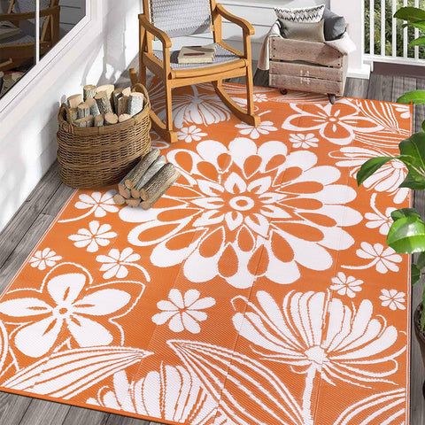 Ileading alfombra exterior frontal mostrando diseño floral naranja y estilismo