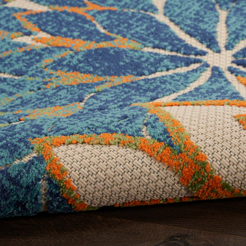 Nourison alfombra Aloha colocada en salón, aporta color