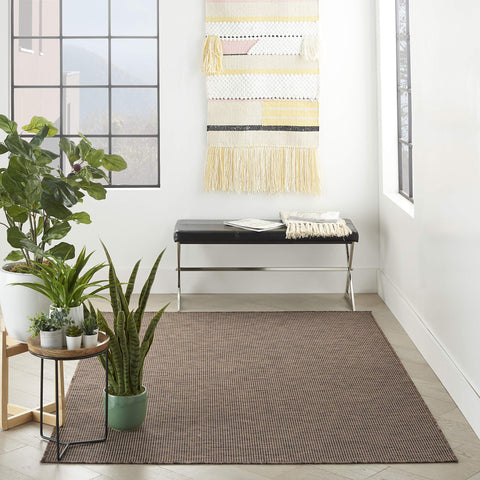Nourison Positano junto a mueble para comparar tamaño 4'x6' práctico