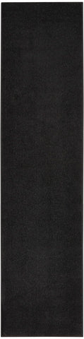 Nourison runner vista frontal mostrando diseño negro y resistencia