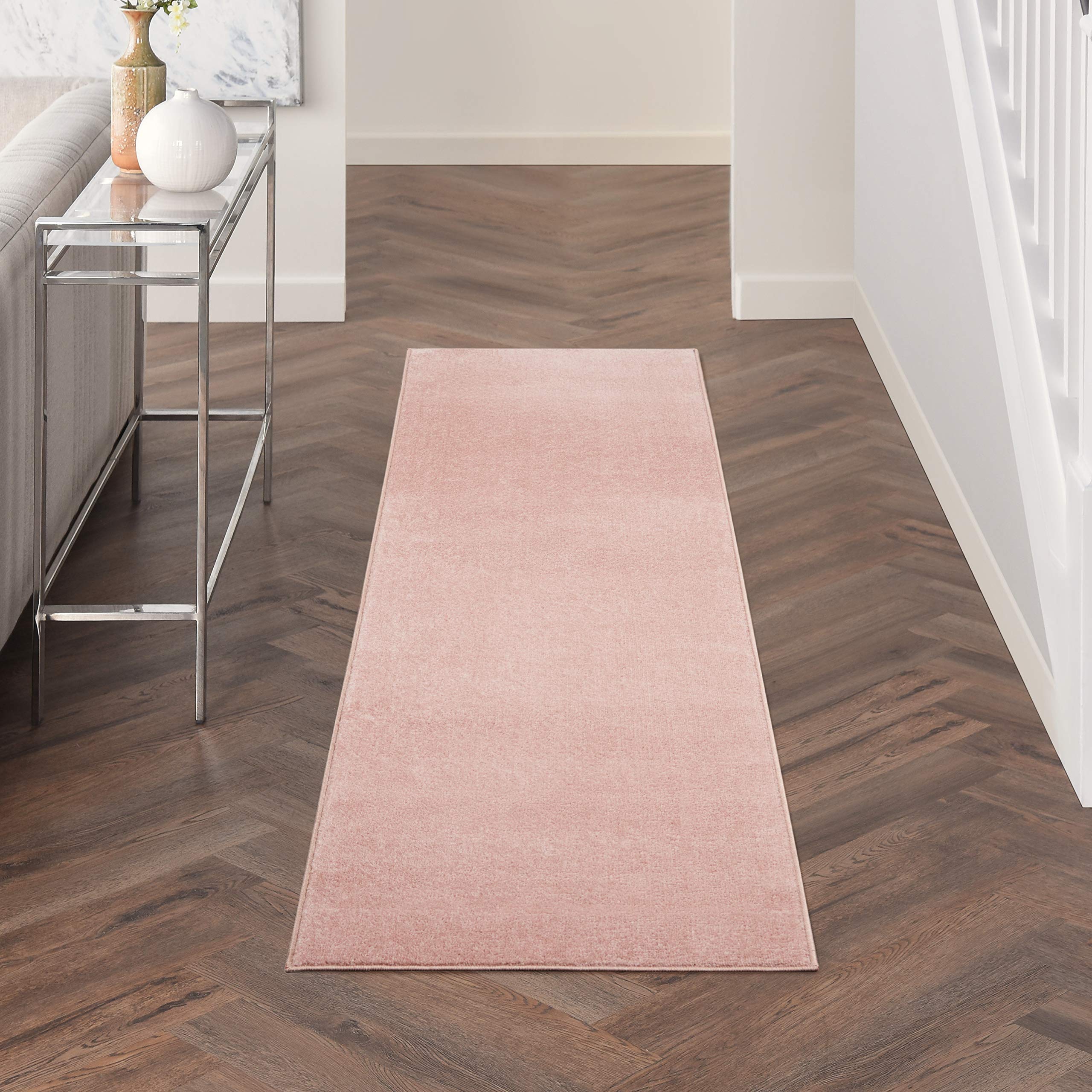 Nourison vista frontal del runner rosa, aporta calidez y diseño